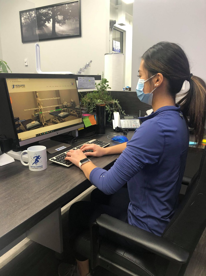 A woman working form home on her dining room table